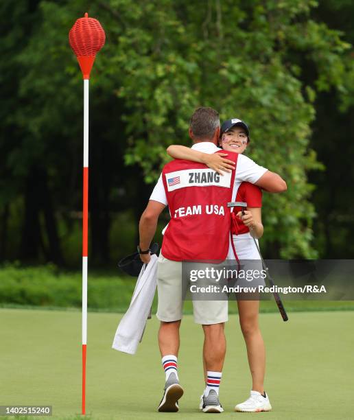 Rose Zhang of Team USA is embraced by her caddie after winning her match on the 13th hole during the Day Three singles matches of The Curtis Cup at...