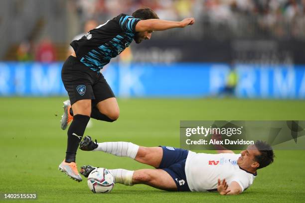 Gary Neville of Team England tackles Kem Cetinay of Team World XI during the Soccer Aid for Unicef 2022 match between Team England and Team World XI...