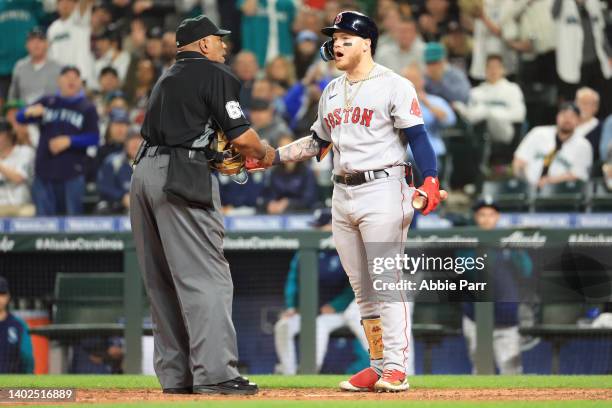 Alex Verdugo of the Boston Red Sox argues with home plate umpire Laz Diaz after ruling his at bat a ground out to catcher to end the top of the...