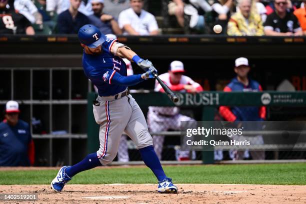 Eli White of the Texas Rangers hits a sacrifice fly to Adam Engel of the Chicago White Sox in the fourth inning at Guaranteed Rate Field on June 12,...