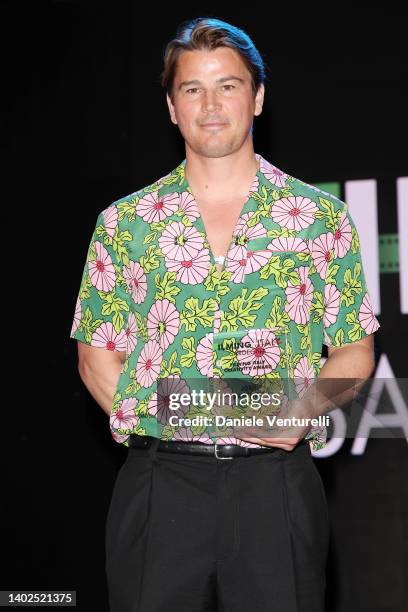 Josh Hartnett poses with the award during the Filming Italy 2022 red carpet on June 12, 2022 in Santa Margherita di Pula, Italy.