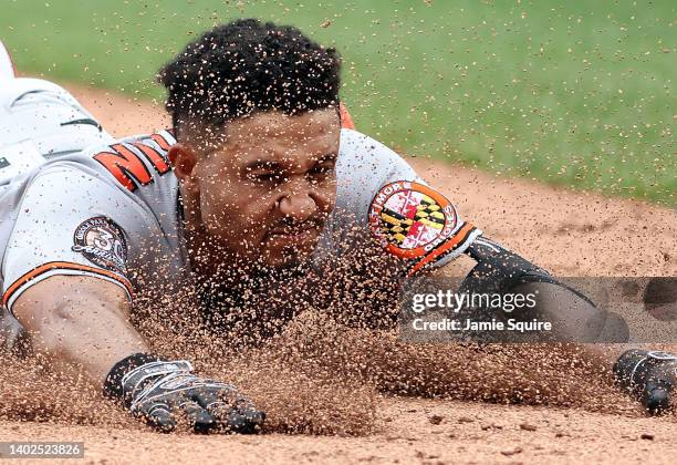 Richie Martin of the Baltimore Orioles slides headfirst into third base for a triple during the 6th inning of the game against the Kansas City Royals...