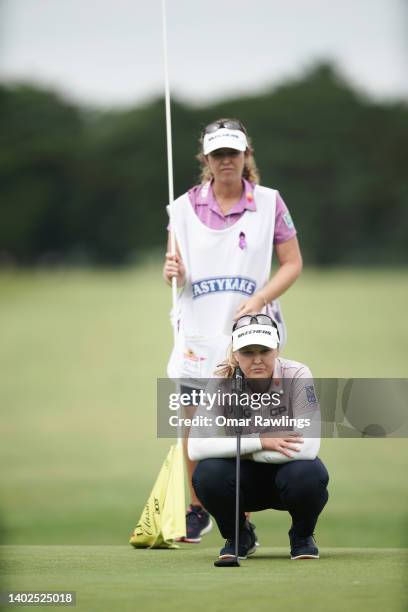 Brooke Henderson of Canada and caddie Ellen Henderson read a putt on the 18th green during the final round of the ShopRite Classic at Seaview Bay...