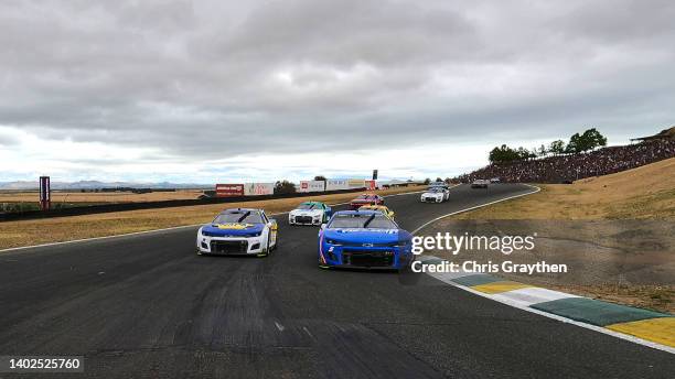 Kyle Larson, driver of the HendrickCars.com Chevrolet, and Chase Elliott, driver of the NAPA Auto Parts Chevrolet, lead the field on a pace lap prior...