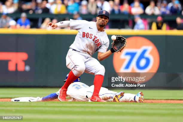 Adam Frazier of the Seattle Mariners beats the throw to Xander Bogaerts of the Boston Red Sox to steal second base during the third inning at...