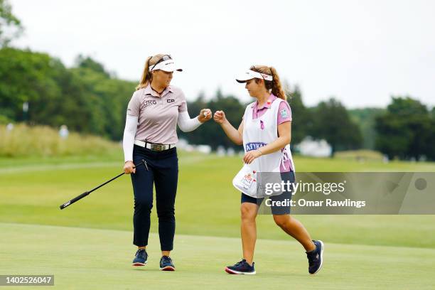 Brooke Henderson of Canada and caddie Ellen Henderson fist bump during the final round of the ShopRite Classic at Seaview Bay Course on June 12, 2022...