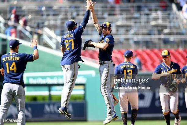 Christian Yelich of the Milwaukee Brewers celebrates with Willy Adames after a 4-1 victory against the Washington Nationals at Nationals Park on June...