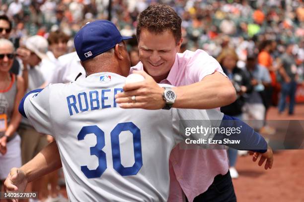 Former San Francisco Giants pitcher Matt Cain hugs Dave Roberts of the Los Angeles Dodgers after Cain threw out the ceremonial first pitch at Oracle...