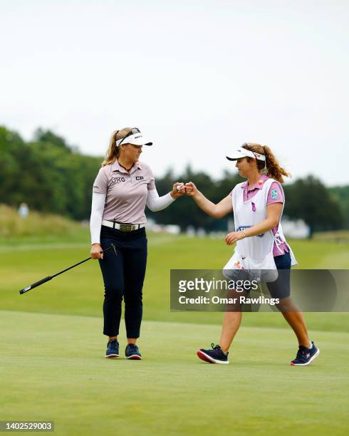 Brooke Henderson of Canada and caddie Ellen Henderson fist bump during the final round of the ShopRite Classic at Seaview Bay Course on June 12, 2022...