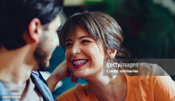 affectionate couple relaxing at home - braces stock pictures, royalty-free photos & images