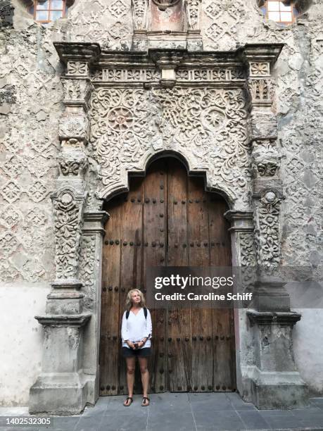 woman standing in front of the church of the immaculate conception, mexico city. - mexico city tourist stock pictures, royalty-free photos & images