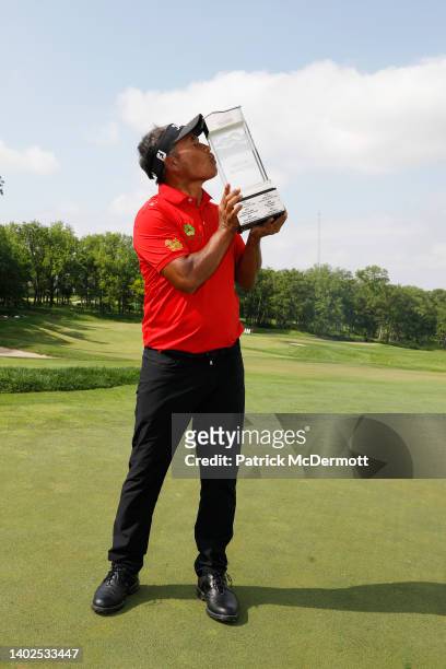 Thongchai Jaidee of Thailand kisses the winner's trophy on the 18th green after winning the American Family Insurance Championship at University...