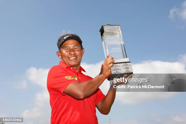 Thongchai Jaidee of Thailand holds the winner's trophy on the 18th green after winning the American Family Insurance Championship at University Ridge...