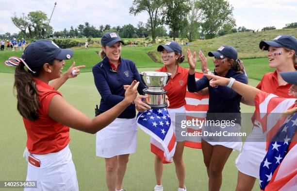 The United States Team captain Sarah LeBrun Ingram gives the Curtis Cup to players Megha Ganne, Rose Zhang, Amari Avery and Emilia Migliocci at the...