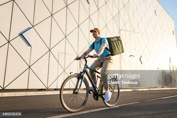 delivery man riding bicycle, delivery service - bicycle messenger stock pictures, royalty-free photos & images