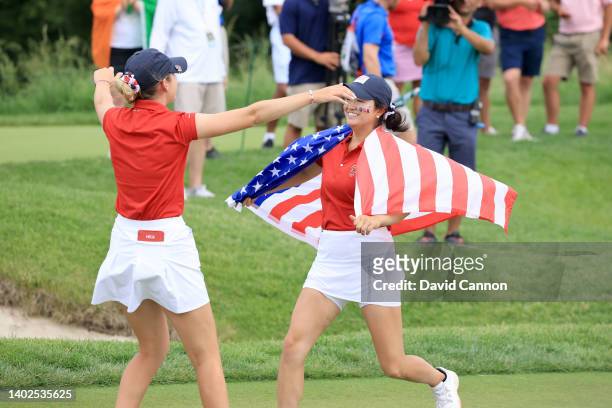 Rachel Heck of The United States Team is congratulated by Rose Zhang after Heck had won her match on the 17th hole against Lauren Walsh during the...