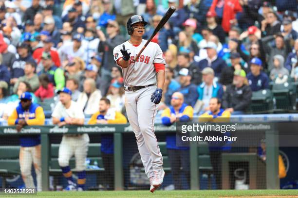 Rafael Devers of the Boston Red Sox flips his bat after hitting a two-run home run against the Seattle Mariners to take a 2-0 lead during the eighth...