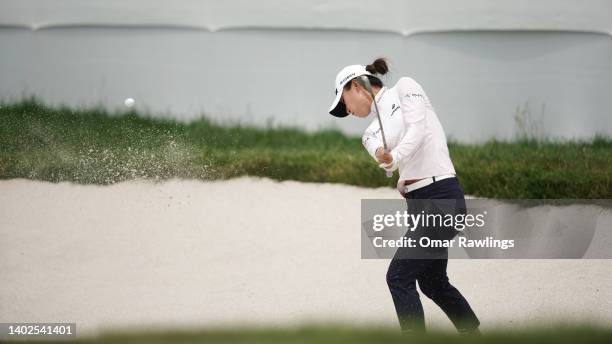 Lydia Ko of New Zealand hits out of a green-side bunker on the 18th during the final round of the ShopRite Classic at Seaview Bay Course on June 12,...