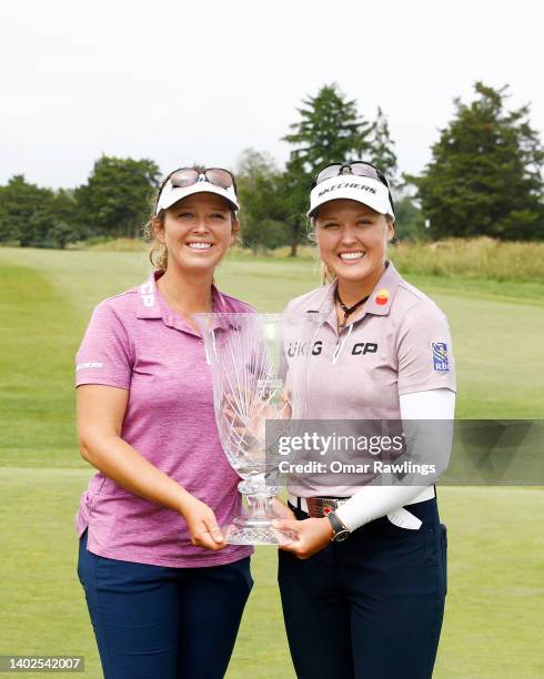 Brooke Henderson of Canada and caddie Ellen Henderson pose with the trophy after Brooke's victory at the ShopRite Classic at Seaview Bay Course on...