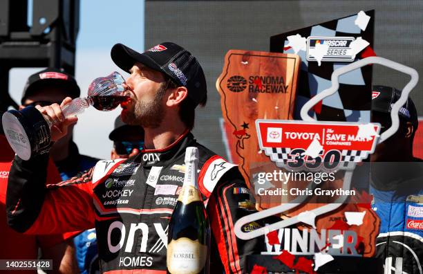 Daniel Suarez, driver of the Onx Homes/Renu Chevrolet, celebrates by drinking wine in victory lane after winning the NASCAR Cup Series Toyota/Save...