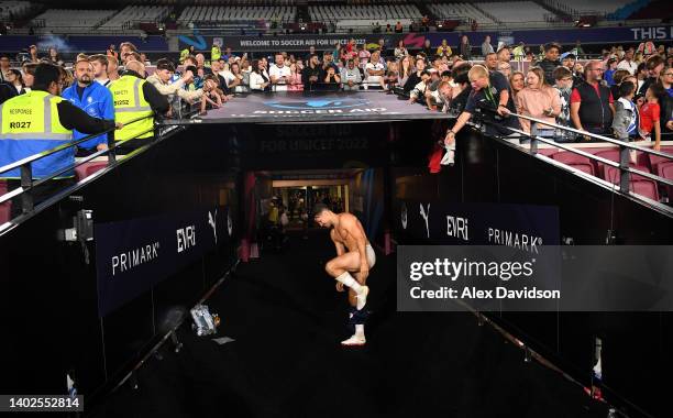 Mark Wright of England takes his shorts off to give to a fan after the Soccer Aid for Unicef 2022 at London Stadium on June 12, 2022 in London,...