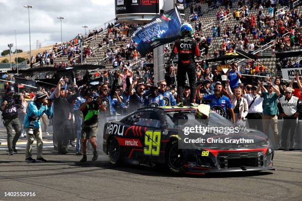 Daniel Suarez, driver of the Onx Homes/Renu Chevrolet, and crew celebrate after winning the NASCAR Cup Series Toyota/Save Mart 350 at Sonoma Raceway...