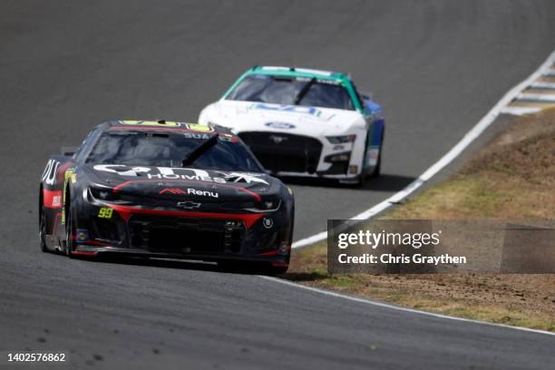 Daniel Suarez, driver of the Onx Homes/Renu Chevrolet, leads Chris Buescher, driver of the Fifth Third Bank Ford, during the NASCAR Cup Series...