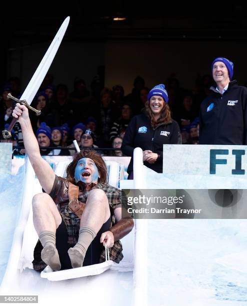 David Neitz, former Melbourne great, goes down the slide as Rebecca Daniher and Neale Daniher look on for Big FightMND Freeze 8, during the round 13...