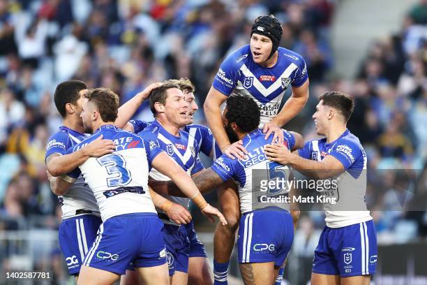 Josh Addo-Carr of the Bulldogs celebrates with team mates after scoring a try during the round 14 NRL match between the Canterbury Bulldogs and the...