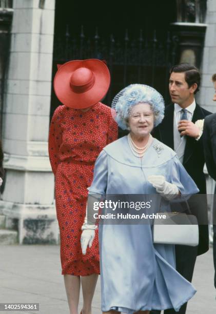British Royals Lady Diana Spencer , wearing a red dress with white, green and blue polka dots and a red hat, the rim of the hat covering her face,...