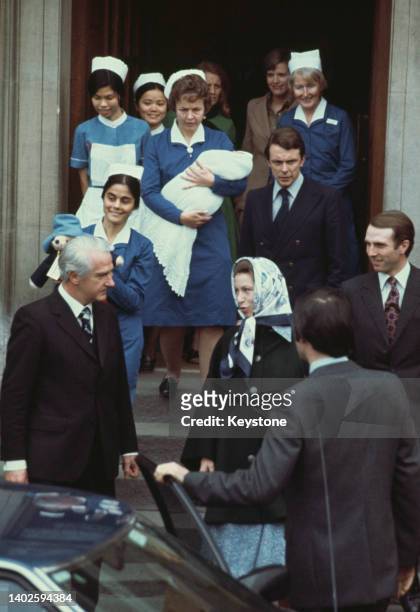 British gynaecologist George Pinker in conversation with Princess Anne who stands beside her husband, British equestrian Captain Mark Phillips, as...