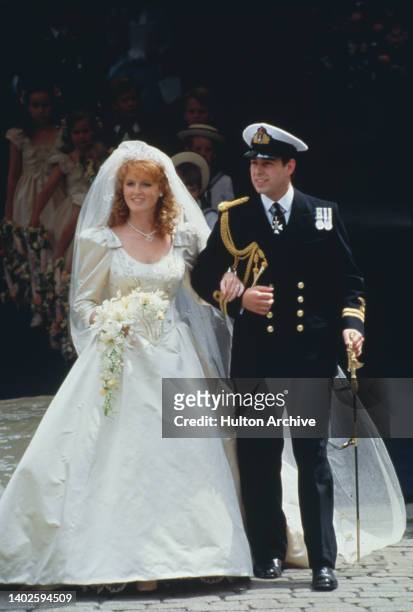 British Royals Sarah, Duchess of York, wearing an ivory-silk Lindka Cierach wedding dress, and Prince Andrew, Duke of York, wearing the ceremonial...