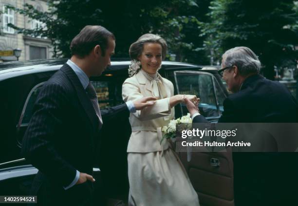 Prince Michael of Kent and Baroness Marie-Christine von Reibnitz, with a man admiring the wedding ring, following their civil ceremony at the Town...