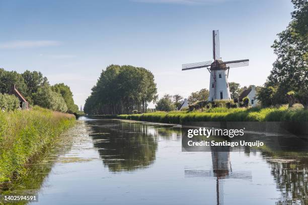 traditional windmill by damse vaart canal - flandern belgien stock-fotos und bilder