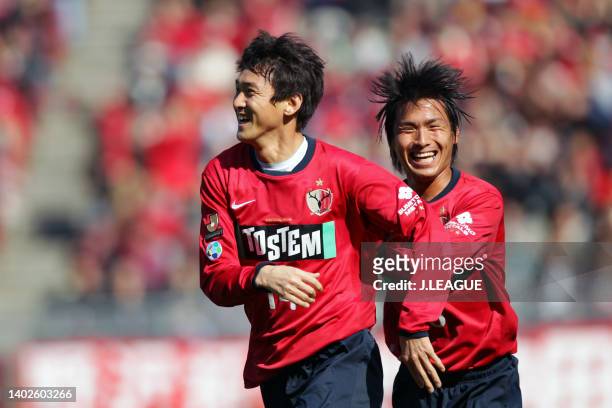 Lee Jung-soo of Kashima Antlers celebrates scoring his side's first goal with his teammate Yasushi Endo during the J.League J1 match between Kashima...