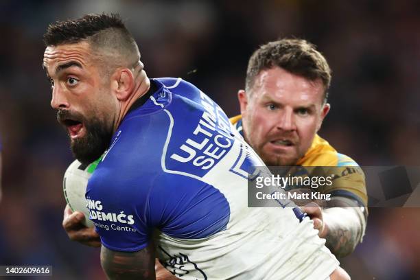 Paul Vaughan of the Bulldogs is tackled by Nathan Brown of the Eels during the round 14 NRL match between the Canterbury Bulldogs and the Parramatta...