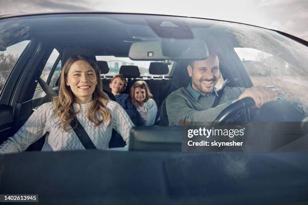 happy family enjoying while going on a vacation by car. - family driving stock pictures, royalty-free photos & images