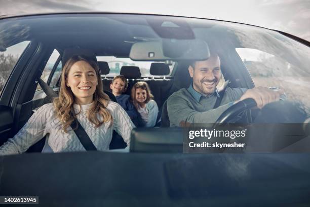happy family enjoying while going on a vacation by car. - car imagens e fotografias de stock