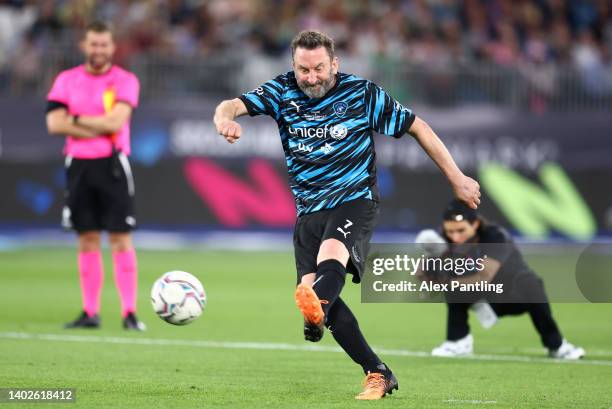 Lee Mack takes and scores the winning penalty during Soccer Aid for Unicef 2022 at London Stadium on June 12, 2022 in London, England.
