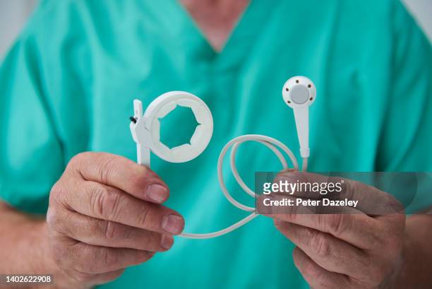 surgeon holding a gastric band - gastric band treatment stock pictures, royalty-free photos & images