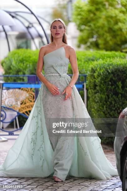Kimberley Garner wears a pale green tulle with embroidered sequined asymmetric shoulder-off long ruffle dress, a white shiny leather small belt, a...