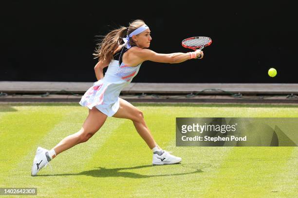 Aleksandra Krunic of Serbia plays a backhand in their Women's Singles First Round match against Petra Martic of Croatia during Day Three of the...