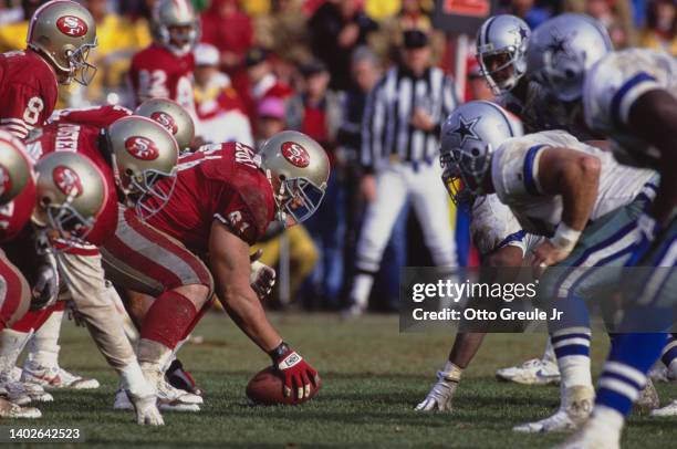 Jesse Sapolu, Center and Offensive Guard for the San Francisco 49ers prepares to snap the football on the line of scrimmage during the National...
