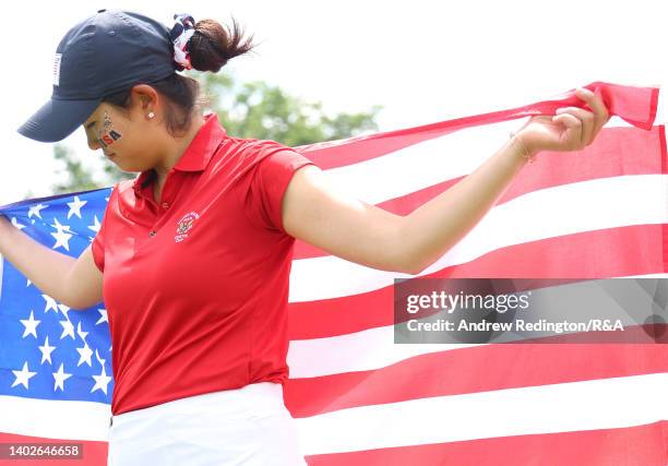 Rose Zhang of Team USA poses with her national flag after winning her point on the way to victory in The Curtis Cup at Merion Golf Club on June 12,...