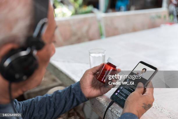 close up smartphone live streaming of a female doctor, telemedicine call - asia broadcast stock pictures, royalty-free photos & images