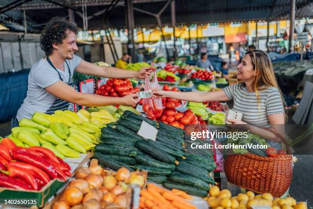 paying with a smile on her face - market vendor stock pictures, royalty-free photos & images