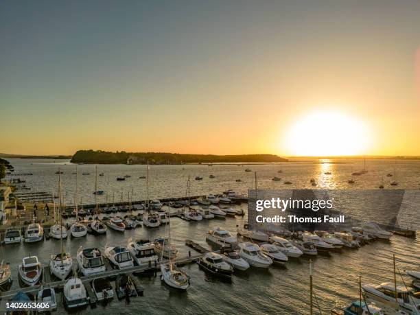 sunset over brownsea island with sandbanks marina - sandbar stock pictures, royalty-free photos & images