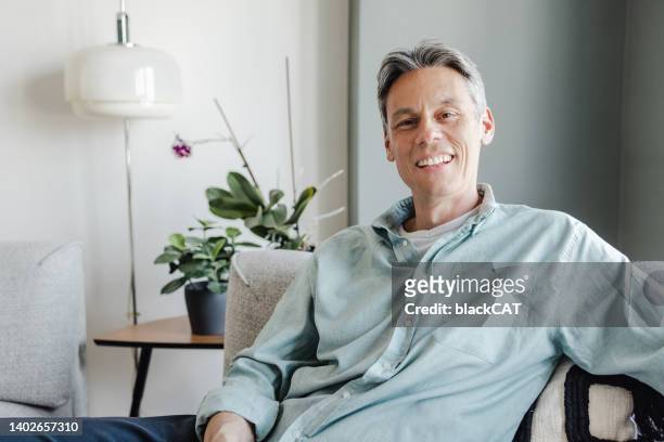 portrait of mature man at home - modern manhood stock pictures, royalty-free photos & images