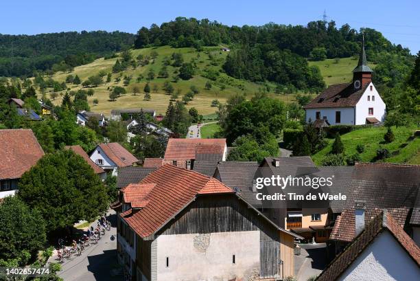 General view of the peloton compete passing through Gelterkinden village landscape during the 85th Tour de Suisse 2022 - Stage 2 a 198km stage from...