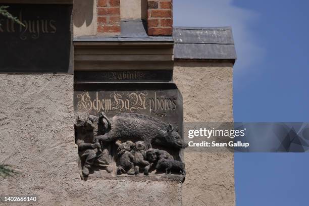 13th century relief depicting Jews suckling from a pig and a rabbi peering into the pig's anus is seen on the facade of St. Mary's town church on...